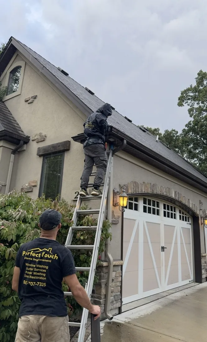 Perfect Touch crew installing gutter guards on a roofline in Glenview IL