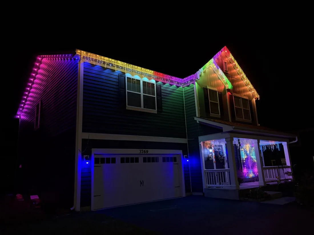 Multicolor permanent roofline lighting on a two-story Schaumburg, IL home — Perfect Touch