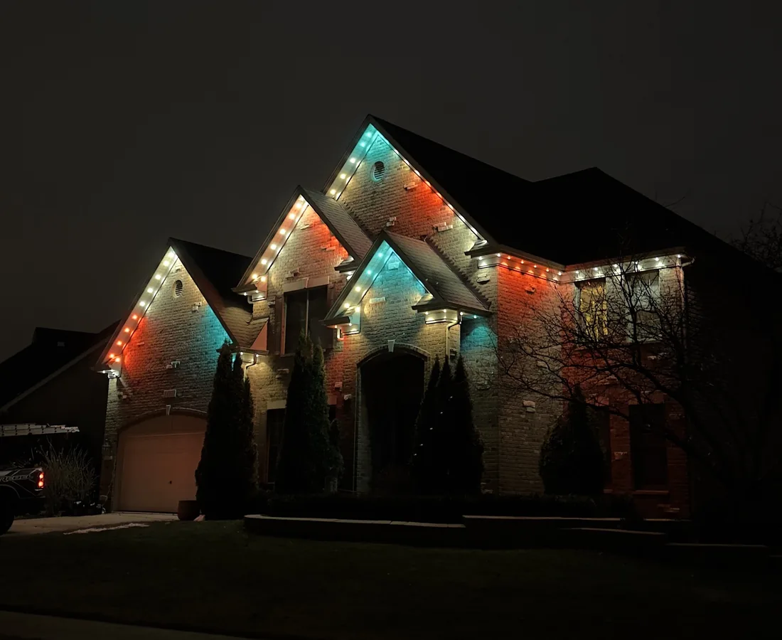 Teal and warm multicolor permanent lighting on a large home in Wheeling, IL — Perfect Touch