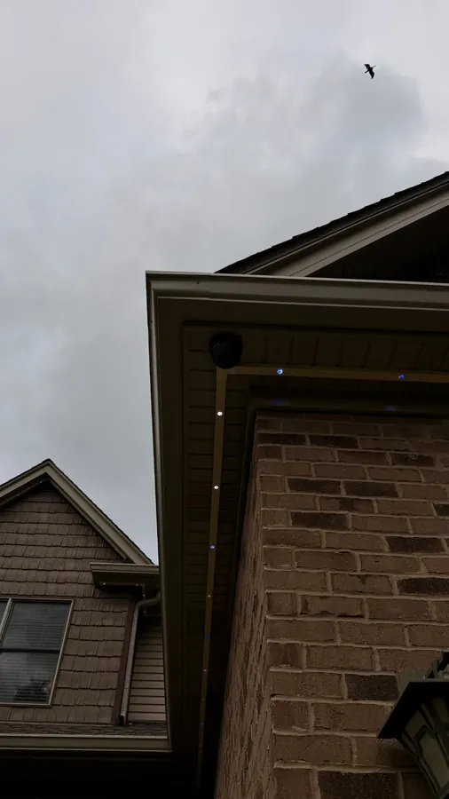 SnapTrack aluminum channel with Govee roofline lights wrapping a brick home corner - Perfect Touch