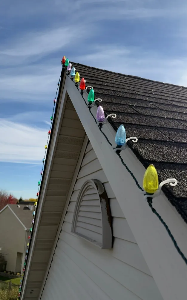 Close-up of multicolor C9 Christmas bulbs along a roofline ridge - Perfect Touch install